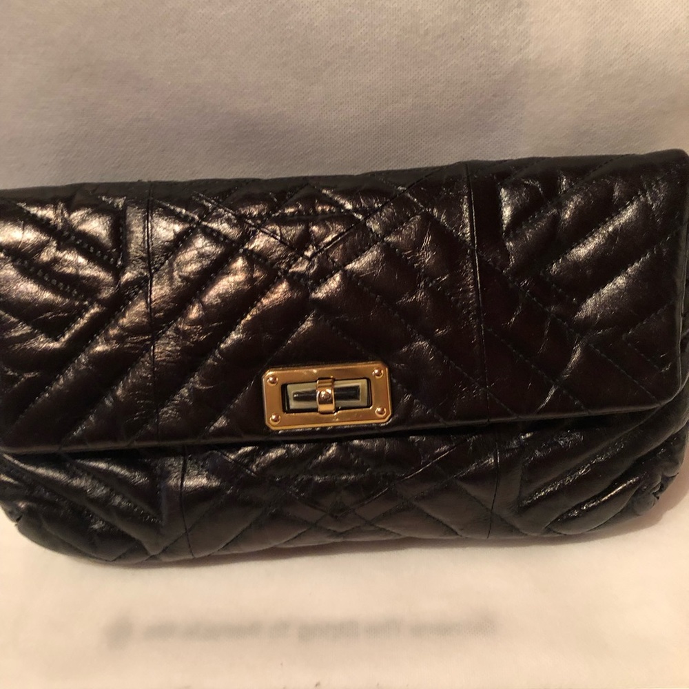 Gorgeous Lanvin black glossy leather quilted clutch with turn lock clasp.